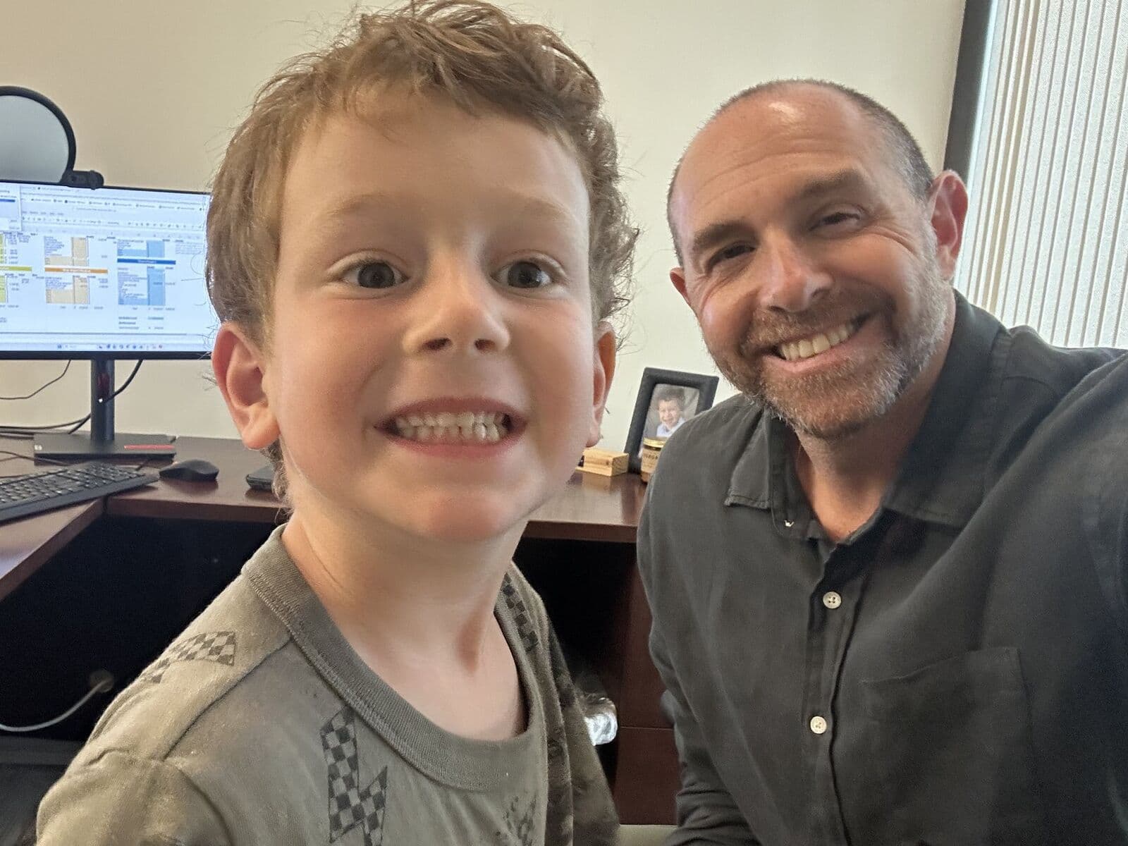 Jason Melvin at the Calabasas office with his son.