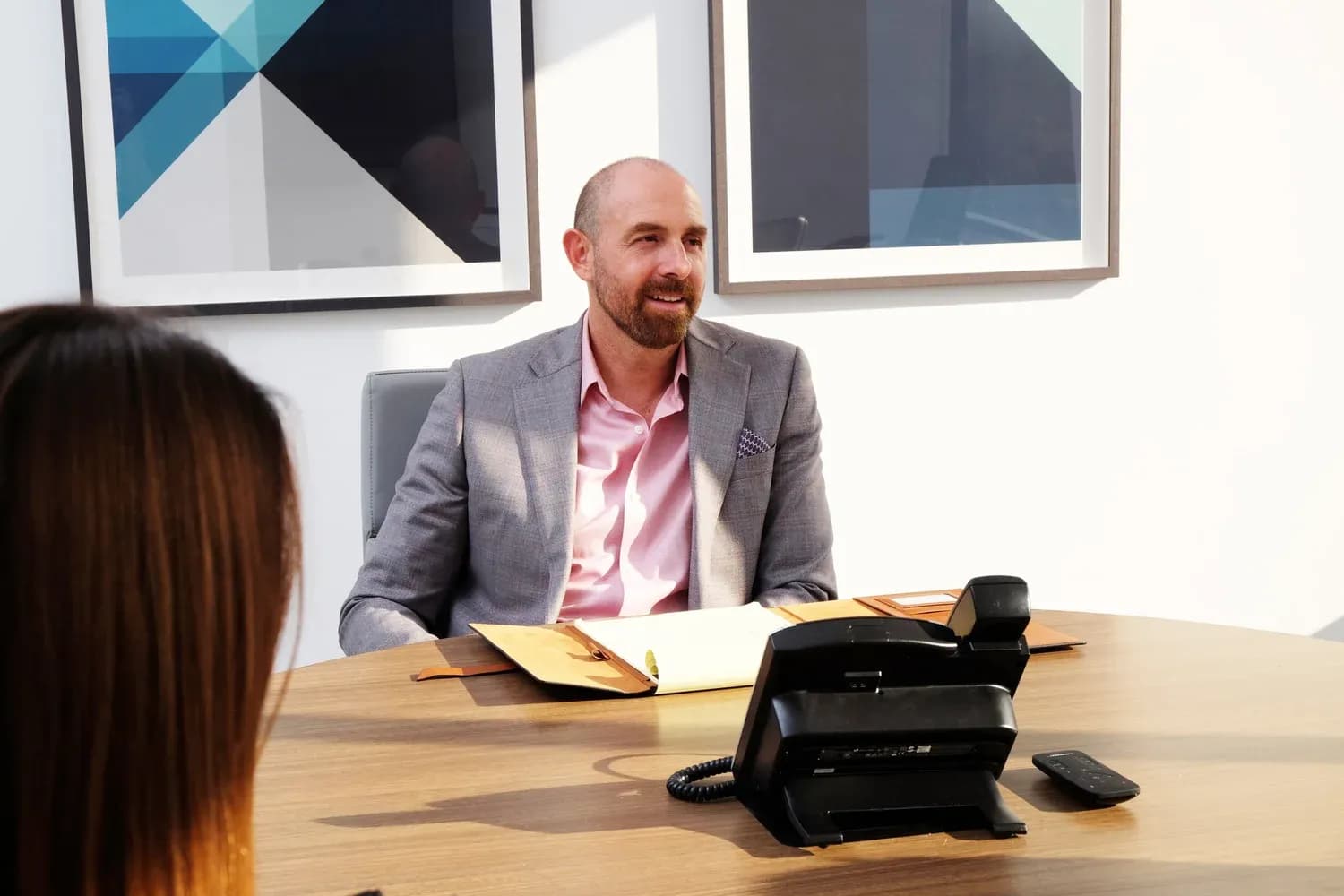 Jason Melvin in conversation with a client at the Calabasas office.
